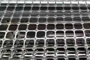 Close view of a black geogrid with rectangular openings.