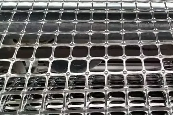 Close view of a black geogrid with rectangular openings.