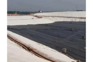 Dark geomembrane sheets lining an excavated basin.